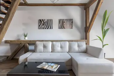 a living room with a white couch and two zebras at ALL SAINTS Residence in Vilnius