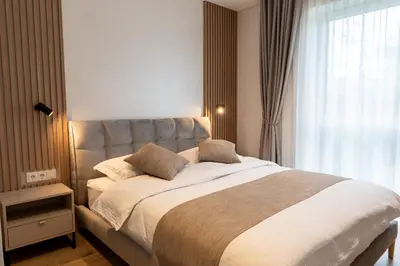 a bedroom with a large bed and a window at Cozy home night and day in Kaunas