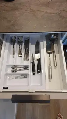 a bunch of utensils are sitting on a counter at Cozy home night and day in Kaunas