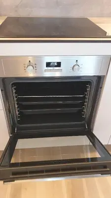 an oven with the door open in a kitchen at Cozy home night and day in Kaunas