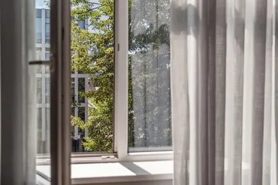 an open window with a view of a tree at Cozy Boho Loft in Vilnius