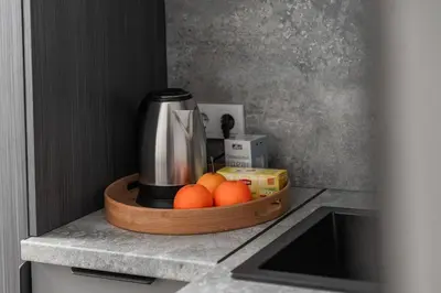 a tray with oranges and a coffee maker on a kitchen counter at Cozy Boho Loft in Vilnius