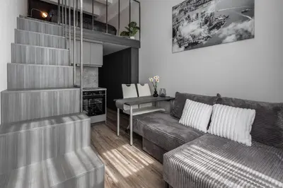 a living room with a couch and a table at Cozy Boho Loft in Vilnius