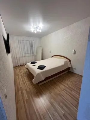 a bedroom with a large bed in a room at J&N Hause 2 in Visaginas