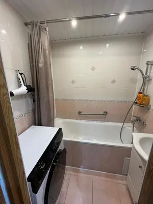 a bathroom with a bath tub and a sink at J&N Hause 2 in Visaginas