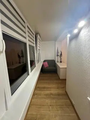 a hallway with a couch and a large window at J&N Hause 2 in Visaginas