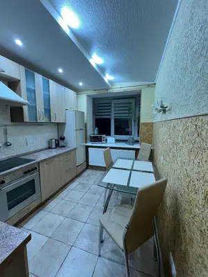 a kitchen with a table and chairs in a room at J&N Hause 2 in Visaginas