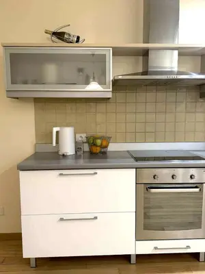 a kitchen with a stove and a counter top at Panorama Apartment Balcony Work Castle View in Vilnius