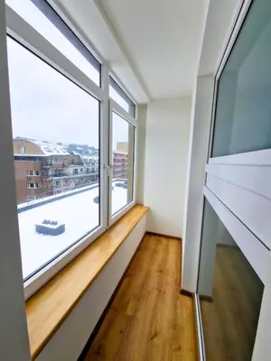 a room with a large window and a wooden floor at Panorama Apartment Balcony Work Castle View in Vilnius