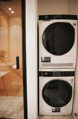 two microwaves stacked on top of each other in a bathroom at City Breeze Flat, Self Ceck-In, Free parking in Vilnius