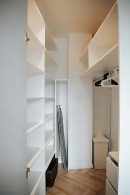 a room with white shelves and a baseball bat at City Breeze Flat, Self Ceck-In, Free parking in Vilnius