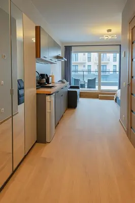 an open kitchen with a large window in a room at Zveryno City Appartments in Vilnius