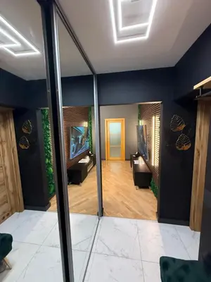 a living room with blue walls and a mirror at Downtown Kaunas - Maironis 10 in Kaunas