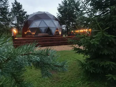 a gazebo with lights in a yard at Skubėk Neskubėti in Klykiai