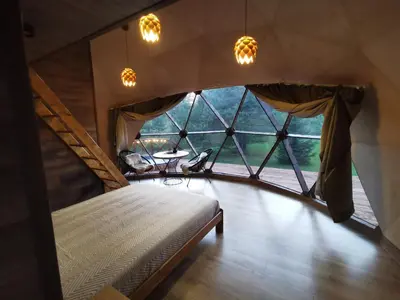 a bedroom with a bed and a large window at Skubėk Neskubėti in Klykiai