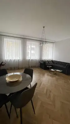 a living room with a table and chairs and a couch at Central Kaunas Luxury Apartment with Free Parking in Kaunas