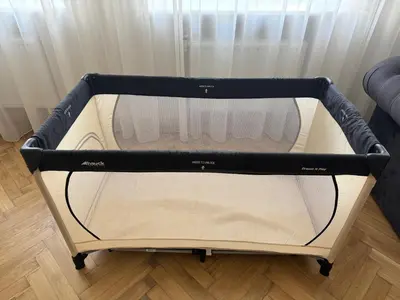 an empty crib in a room with a window at Central Kaunas Luxury Apartment with Free Parking in Kaunas