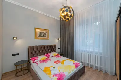 a bedroom with a bed and a large window at The Comfort Apartment #1 by Polo Apartments in Kaunas