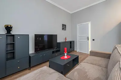a living room with a couch and a flat screen tv at The Comfort Apartment #1 by Polo Apartments in Kaunas
