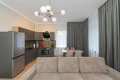 a kitchen and living room with a couch and a table at The Comfort Apartment #1 by Polo Apartments in Kaunas