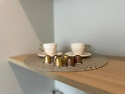 a tray with two cups on a table withocolates at Pušų nata in Druskininkai