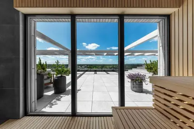 a room with sliding glass doors looking out onto a patio at Pušų nata in Druskininkai