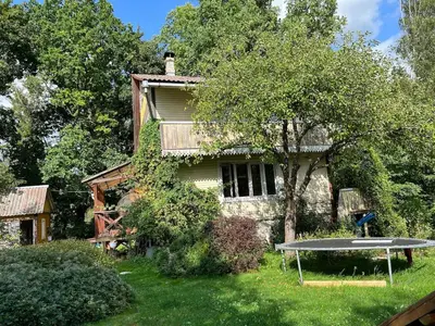a house with a picnic table in the yard at Beloved Family Nest in Vosyliukai