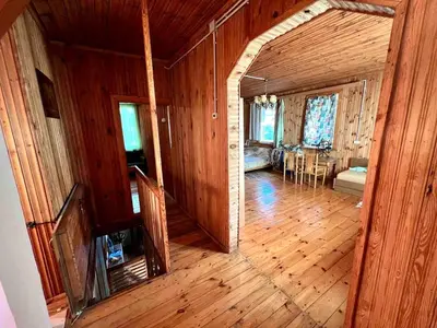 a large room with a wooden floor and a dining room at Beloved Family Nest in Vosyliukai
