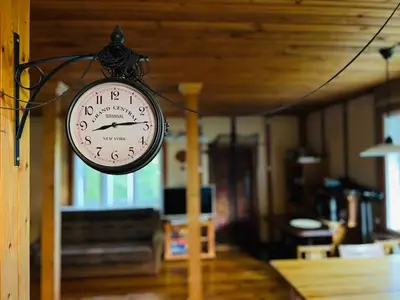 a clock hanging on a wall in a room at Beloved Family Nest in Vosyliukai