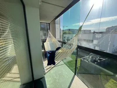 a hammock on the balcony of a house at My home Vilnius in Vilnius