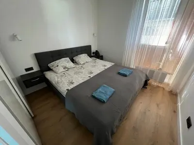 a bedroom with a bed with two pillows on it at My home Vilnius in Vilnius