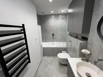 a bathroom with a sink and a toilet and a tub at My home Vilnius in Vilnius
