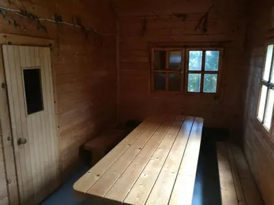 a room with a wooden bench in a cabin at Kaimo turizmo sodyba