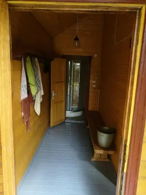 an internal hallway of a cabin with a door and a hallway at Kaimo turizmo sodyba