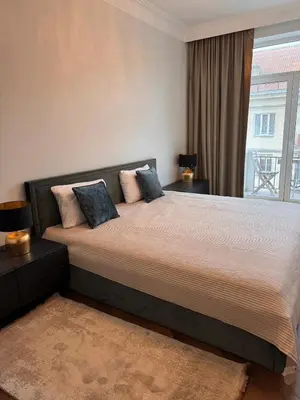a bedroom with a large bed with a window at Monacco in Šiauliai