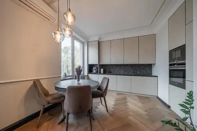 a kitchen with a dining room table and chairs at Monacco in Šiauliai