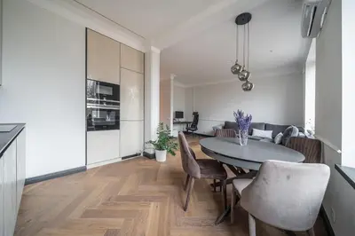 a kitchen and dining room with a table and chairs at Monacco in Šiauliai