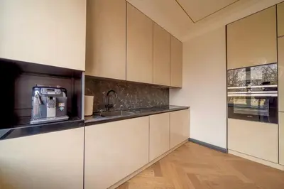 a kitchen with white cabinets and a sink at Monacco in Šiauliai