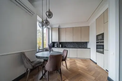 a kitchen with a table and chairs in a room at Monacco in Šiauliai