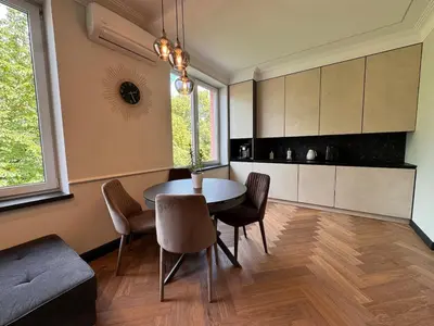 a kitchen with a table and chairs in a room at Monacco in Šiauliai
