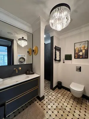 a bathroom with a tub and a toilet and a chandelier at Monacco in Šiauliai
