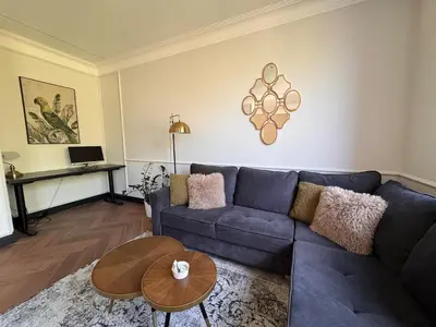 a living room with a blue couch and a table at Monacco in Šiauliai
