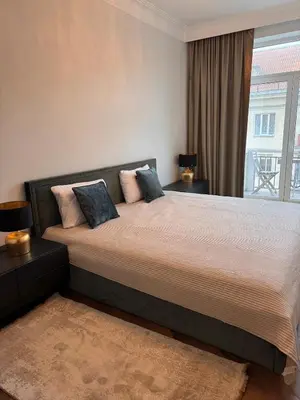 a bedroom with a large bed with a window at Monacco in Šiauliai