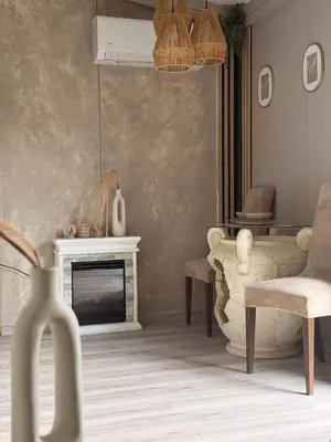 a living room with a fireplace and a chair at Forest Resort house