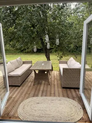 a patio with a table and couches and a tree at Forest Resort house