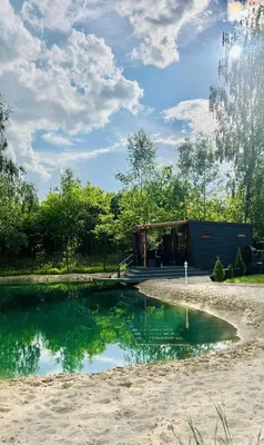 a small pool of water in front of a building at Forest Resort house