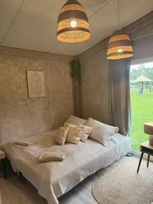 a bedroom with a bed with pillows on it at Forest Resort house