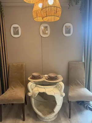 a table with two chairs and a table with plates on it at Forest Resort house