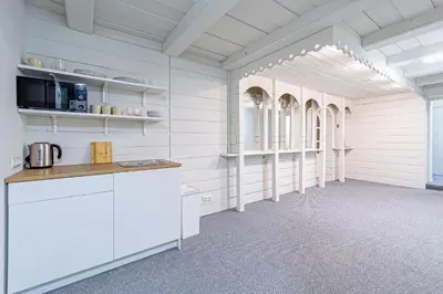 a kitchen with white cabinets and a counter in a room at STAY Kaunas city center in Kaunas