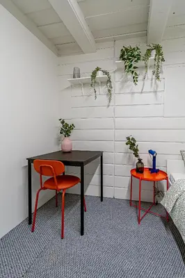 a room with a table and two chairs and plants at STAY Kaunas city center in Kaunas